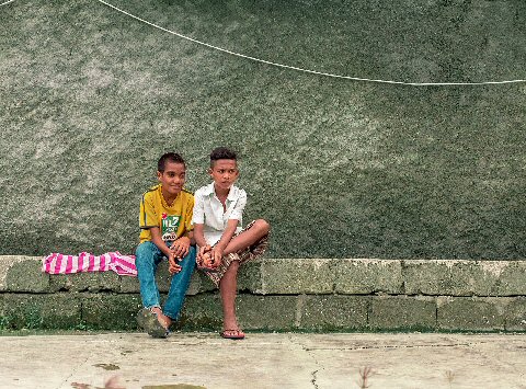 two boys sitting down