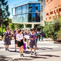 school students walking past AEB