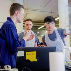 three students in a lab