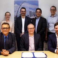 Front row: UQ School of Civil Engineering head Professor Simon Washington, UQ Director of Research Partnerships Joe McLean, VLC CEO Tim Veitch. UQ's Dr Jake Whitehead (back row, third from left)