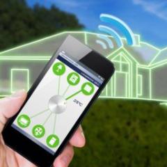 graphical image of smartphone held in a had in front of the outline drawing of a home