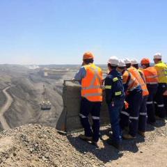 students overlooking open cut mine