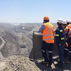 students overlooking open cut mine