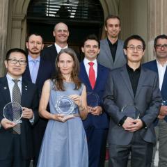 Dr Alistair Grinham (back left), Professor Carlo Prato (second row middle) and Dr Peggy Schrobback (front row middle) receive their Partners in Research Excellence Award.