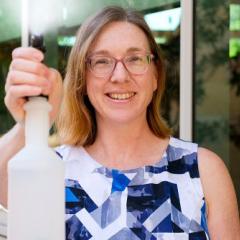 image of woman using spray bottle