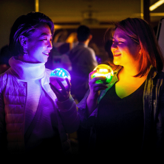 two women playing with light spheres