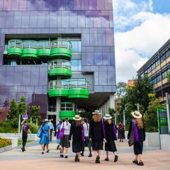 students walking to liveris building
