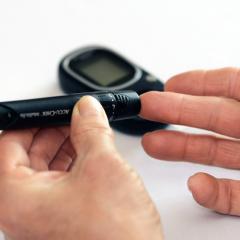 image of hand holding diabetic tester