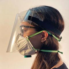 profile view of female wearing face shield and face mask