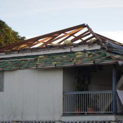 house with damaged roof from cyclone debbie