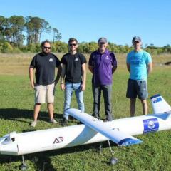 Dawid Preller, Hugh Cronin, and Stuart Loughrey with Professor Michael Smart at the flight test of a prototype fly-back rocket booster. 