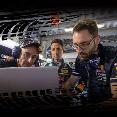 Image of men looking at laptop